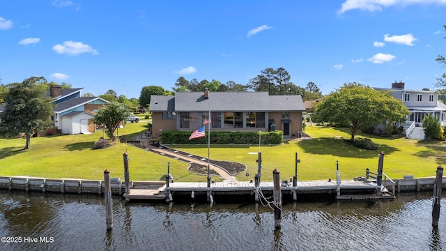 back of house featuring a water view and a yard