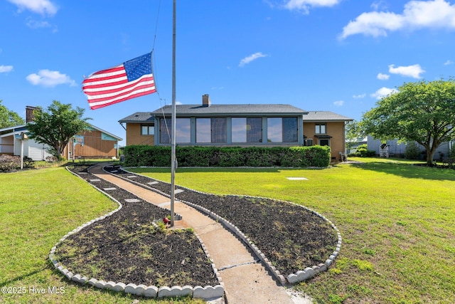 back of property featuring a yard