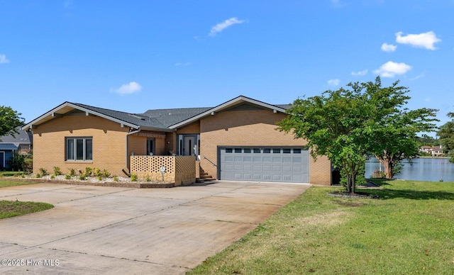 single story home featuring brick siding, driveway, a front lawn, and a garage