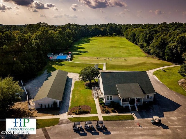 birds eye view of property with a forest view