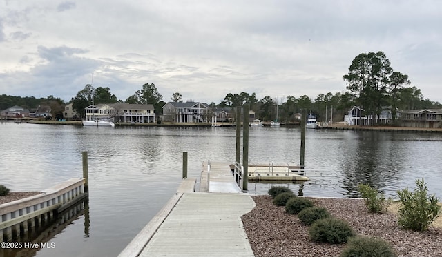view of dock featuring a residential view and a water view