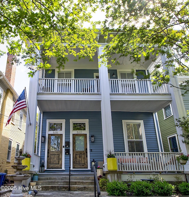 view of front of property with a balcony and covered porch
