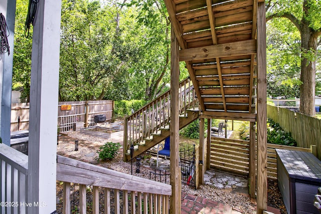 deck with stairway and a fenced backyard