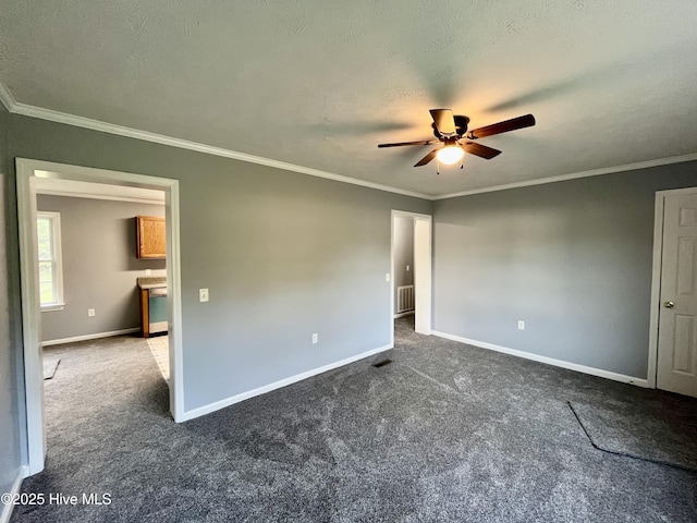 unfurnished bedroom with ceiling fan, baseboards, dark carpet, and ornamental molding