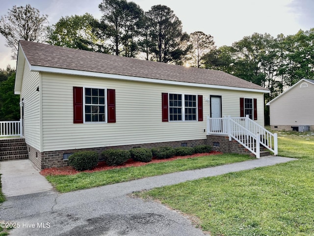 view of front of property with crawl space, a front lawn, roof with shingles, and cooling unit