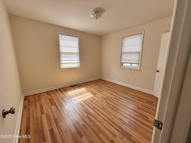 1010 Warren St, Clinton, NC 28328 - unfurnished room featuring plenty of natural light, light wood-style flooring, and baseboards