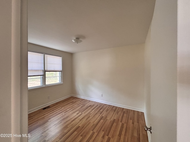 1010 Warren St, Clinton, NC 28328 - spare room with wood finished floors and baseboards