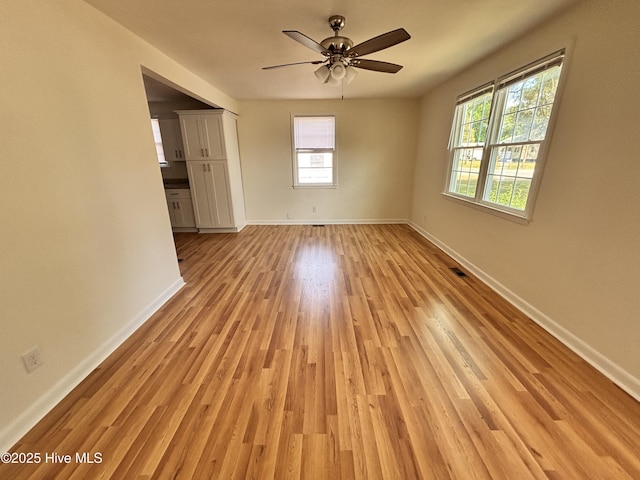 1010 Warren St, Clinton, NC 28328 - unfurnished room with light wood finished floors, ceiling fan, and baseboards