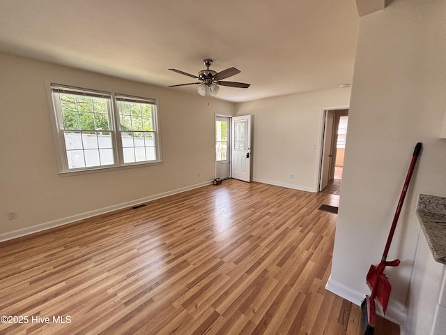 1010 Warren St, Clinton, NC 28328 - unfurnished room with a ceiling fan, light wood-type flooring, and baseboards