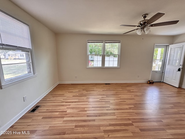 1010 Warren St, Clinton, NC 28328 - spare room with plenty of natural light, light wood-type flooring, and a ceiling fan