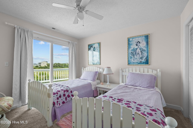 105 Island Quay Ct, Atlantic Beach, NC 28512 - bedroom with carpet floors, a textured ceiling, visible vents, and ceiling fan