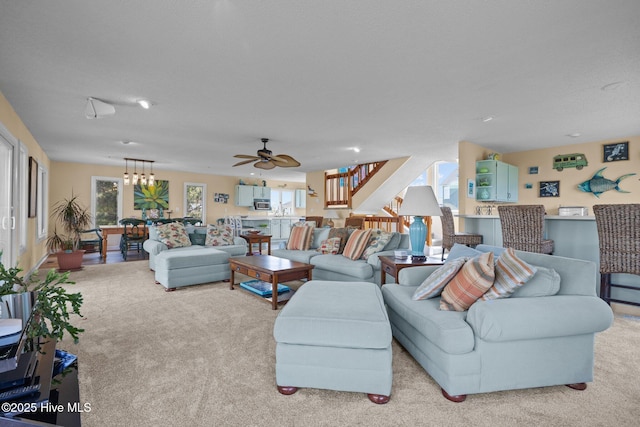 105 Island Quay Ct, Atlantic Beach, NC 28512 - living room with stairs, a ceiling fan, and light carpet