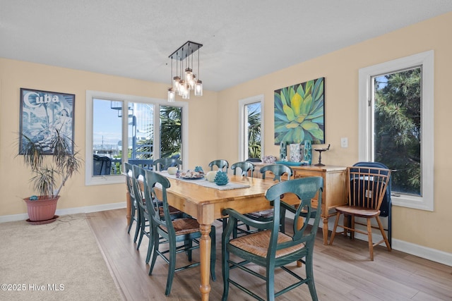105 Island Quay Ct, Atlantic Beach, NC 28512 - dining area with an inviting chandelier, baseboards, and light wood finished floors