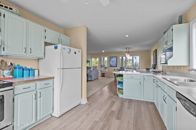 105 Island Quay Ct, Atlantic Beach, NC 28512 - kitchen with a sink, light wood-style floors, range, freestanding refrigerator, and dishwashing machine