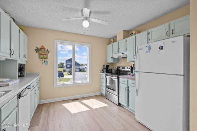 105 Island Quay Ct, Atlantic Beach, NC 28512 - kitchen with ceiling fan, visible vents, light wood-type flooring, light countertops, and white appliances