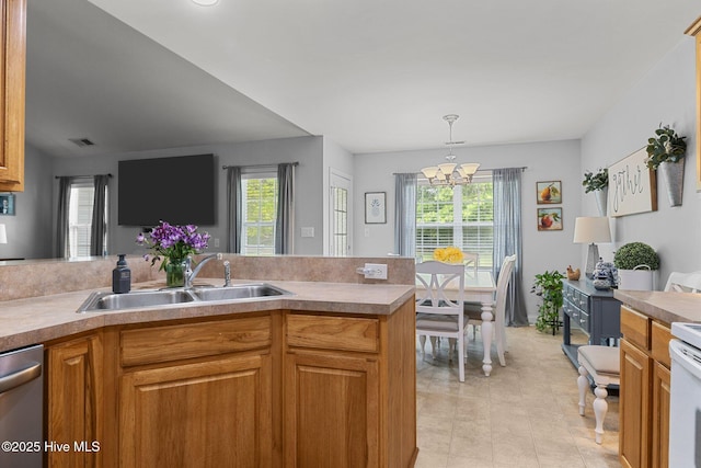 202 Two Oaks Ct, Newport, NC 28570 - kitchen featuring stainless steel dishwasher, a sink, pendant lighting, a notable chandelier, and visible vents