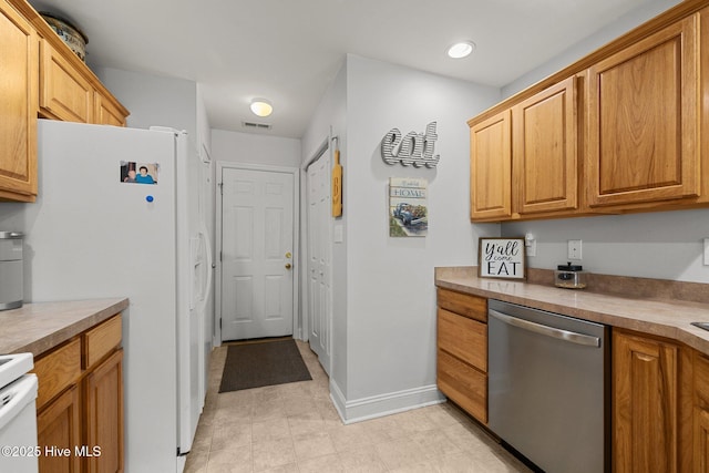 202 Two Oaks Ct, Newport, NC 28570 - kitchen with white fridge with ice dispenser, visible vents, baseboards, dishwasher, and range