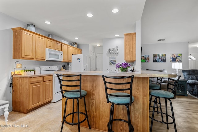 202 Two Oaks Ct, Newport, NC 28570 - kitchen with open floor plan, white appliances, light countertops, a kitchen bar, and recessed lighting