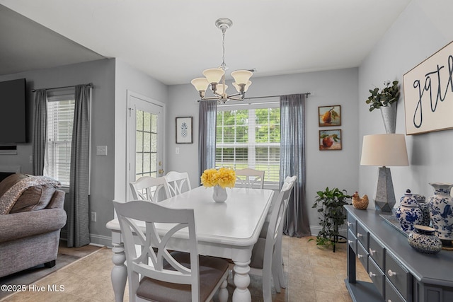 202 Two Oaks Ct, Newport, NC 28570 - dining area featuring baseboards, light tile patterned flooring, and a chandelier