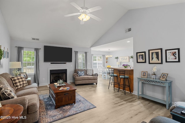 202 Two Oaks Ct, Newport, NC 28570 - living room with visible vents, wood finished floors, ceiling fan with notable chandelier, and a fireplace
