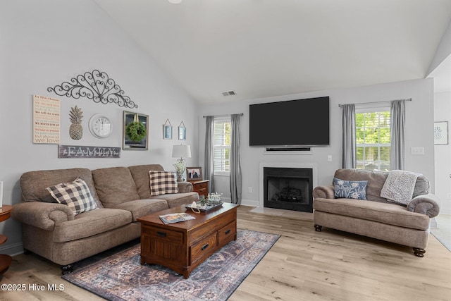 202 Two Oaks Ct, Newport, NC 28570 - living area with high vaulted ceiling, light wood-style floors, visible vents, and plenty of natural light