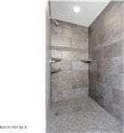 bathroom featuring tiled shower