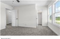 unfurnished bedroom featuring carpet floors and baseboards