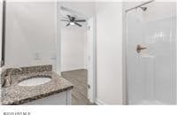 bathroom with vanity and a shower