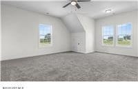 bonus room featuring lofted ceiling and a ceiling fan