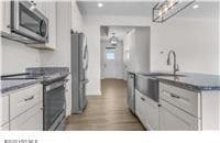 kitchen featuring stainless steel appliances, recessed lighting, and dark wood finished floors