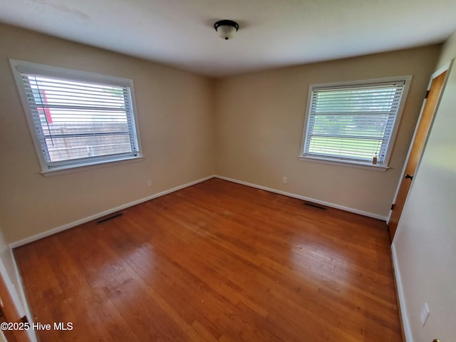 2703 Langston Dr, Goldsboro, NC 27534 - spare room featuring visible vents, wood finished floors, and baseboards