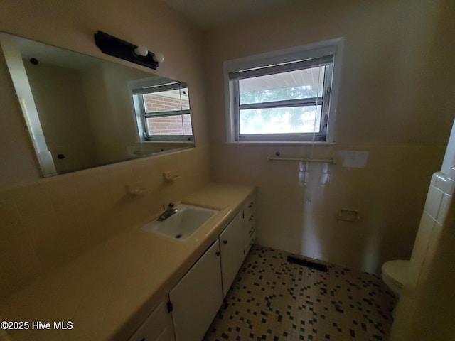 2703 Langston Dr, Goldsboro, NC 27534 - bathroom featuring toilet, tile walls, and vanity