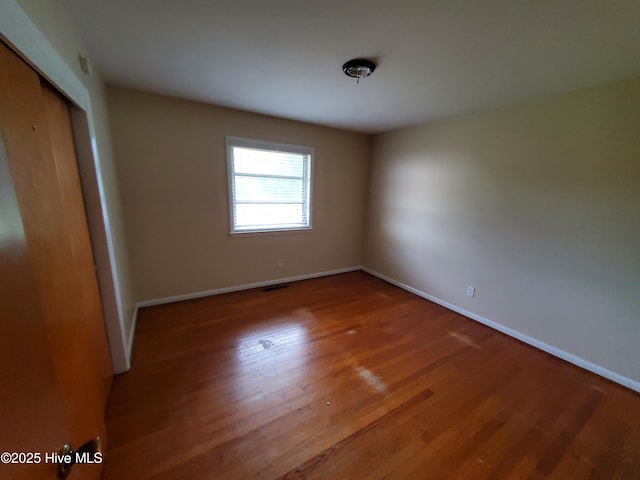 2703 Langston Dr, Goldsboro, NC 27534 - unfurnished bedroom with baseboards, a closet, visible vents, and wood finished floors