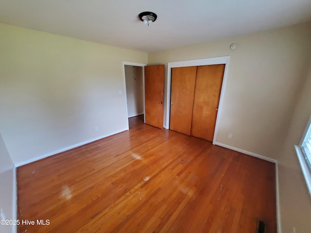 2703 Langston Dr, Goldsboro, NC 27534 - unfurnished bedroom with baseboards, light wood finished floors, a closet, and visible vents