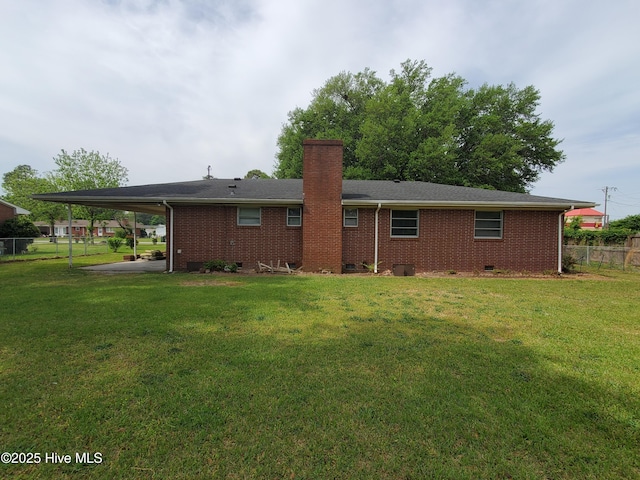 2703 Langston Dr, Goldsboro, NC 27534 - rear view of house featuring brick siding, a yard, a chimney, and fence