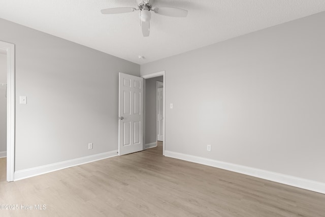 315 Whirlaway Blvd, Sneads Ferry, NC 28460 - unfurnished bedroom featuring light wood-type flooring, baseboards, a ceiling fan, a spacious closet, and a textured ceiling