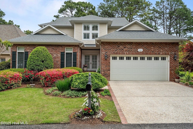 traditional home with a garage, a front lawn, driveway, a shingled roof, and french doors