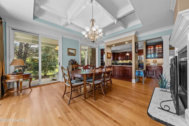 dining area featuring crown molding, light wood-style flooring, a chandelier, beamed ceiling, and coffered ceiling