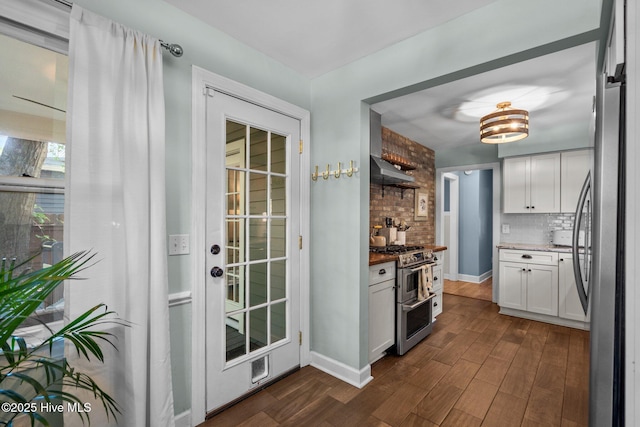 kitchen featuring decorative backsplash, dark wood finished floors, under cabinet range hood, stainless steel appliances, and white cabinetry