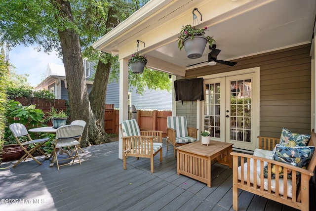 deck featuring french doors, fence, an outdoor hangout area, and ceiling fan