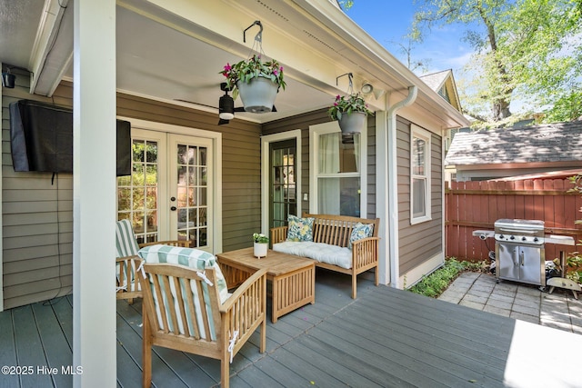deck featuring grilling area, fence, and french doors