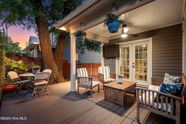 deck featuring fence, french doors, and outdoor lounge area