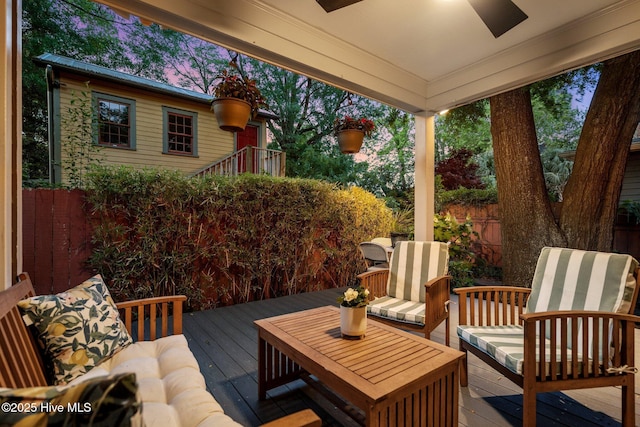 wooden terrace featuring fence and a ceiling fan
