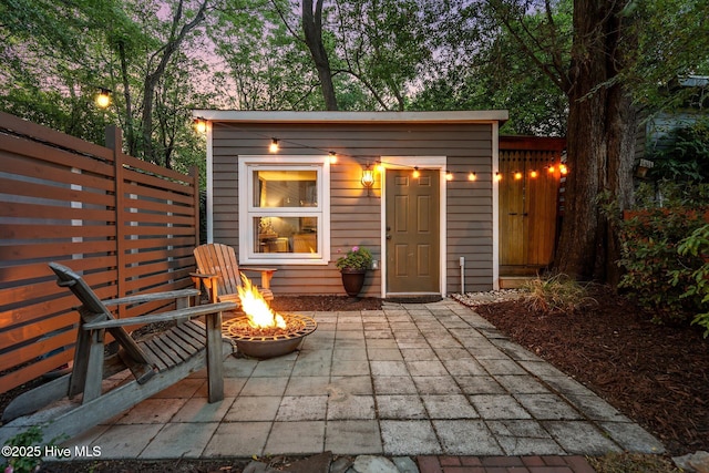 view of outbuilding featuring an outdoor fire pit