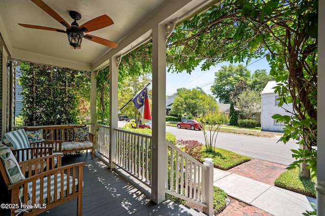 wooden deck featuring a ceiling fan and a porch