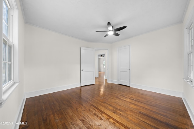 unfurnished bedroom featuring wood finished floors, a ceiling fan, baseboards, and ornamental molding