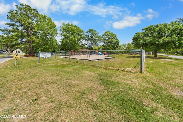view of yard featuring fence and playground community