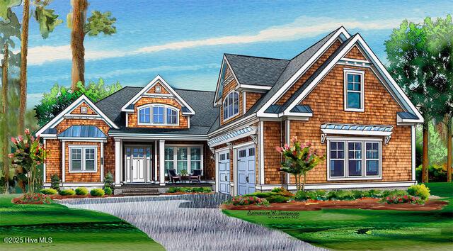 view of front facade with an attached garage, driveway, and a front lawn
