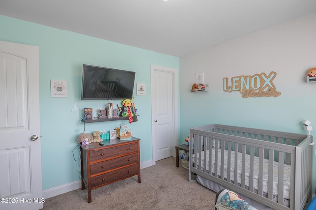 bedroom featuring carpet floors, a nursery area, and baseboards
