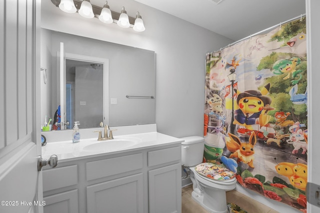 bathroom with toilet, a shower with shower curtain, tile patterned flooring, and vanity